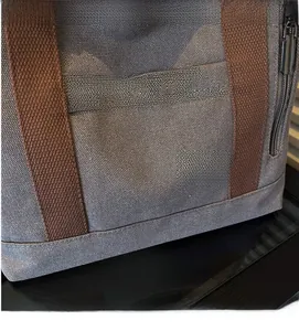 Detail of high-density canvas tote with dark brown webbing and secure metal hardware