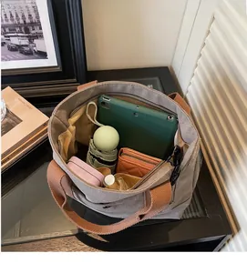Macro detail of spacious grey canvas tote bag interior showing organized daily essentials