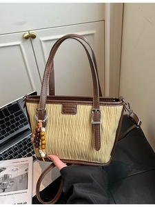 Retro cream pleated tote bag with dark brown leather trim and chic wooden bead accessory