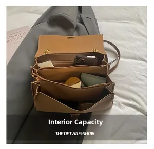 Detail view of large capacity brown leather tote bag with multiple interior compartments
