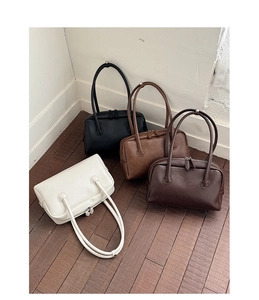 Collection of minimalist Boston handbags in cream, black, caramel, and dark brown colors