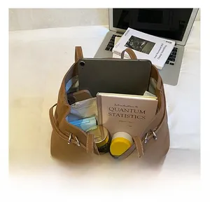 Interior view showing large capacity for tablet, books and cosmetics in brown tote bag