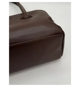 Detail of thickened base on dark brown leather tote bag for structure and durability