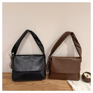 Minimalist oil wax leather tote bags in black and coffee shown side-by-side on a wooden table