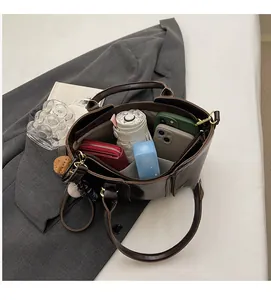 Top view of deep brown tote bag interior showing spacious compartments for daily items