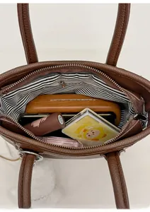 Top view of spacious interior of dark brown leather tote bag with striped lining