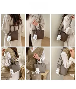 Chic bucket bag in coffee and taupe tones styled with a plush puppy charm and trench coat