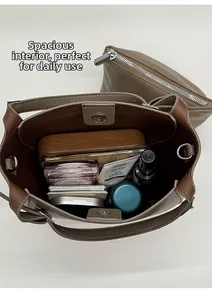 Spacious interior of brown pebbled leather bucket bag showing large storage capacity