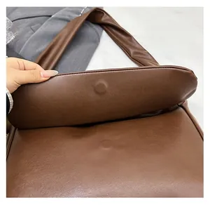 Detail view of the hidden magnetic closure on the dark brown vintage leather tote bag