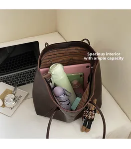 Macro view of a deep brown tote bag interior showing its high-capacity storage for tablets