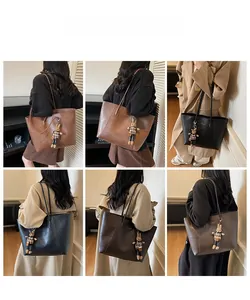 Detailed views of large tote bag with cute bunny pendant in brown and black leather
