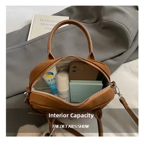 Interior view of brown leather bag showing large capacity for phone and cosmetics