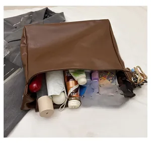 Interior view showing large capacity of the brown faux leather tote with daily items
