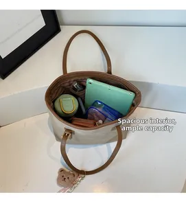 Detailed interior of a spacious tote bag holding a tablet, water bottle, and wallet