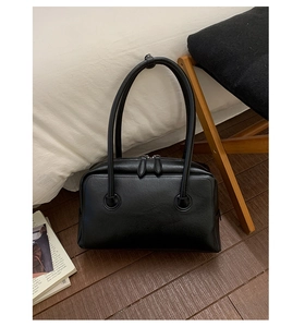 Detail of black Boston shoulder bag with long handles and textured leather finish