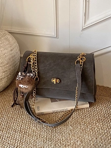 Minimalist charcoal grey suede tote bag with golden chain and cute plush pendant charm