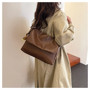 Detail of dark brown oil wax leather tote bag showing rich texture and vintage finish
