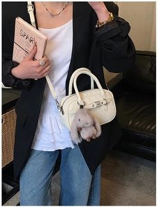 Chic cream-white bowling bag with faux leather strap and cute grey rabbit charm detail