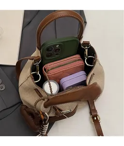 Top view of beige bucket bag showing interior space with phone and wallet inside