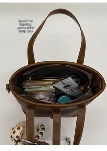 Interior view of brown lychee grain leather tote bag showing large storage capacity