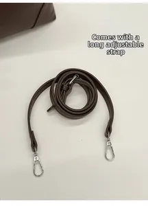 Detail of adjustable brown leather shoulder strap with durable silver metal lobster clasp