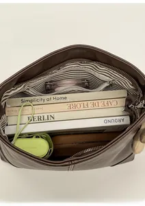 Interior view of brown leather tote showing spacious main compartment and striped zipper pocket