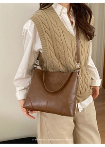 Detail showing the brown vintage tote bag with fine stitching and slim shoulder straps