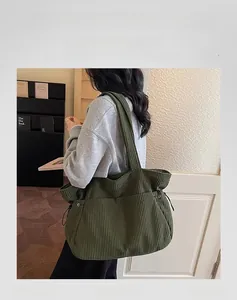 Detail of army green corduroy tote bag showing large capacity and textured fabric