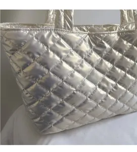 Close-up of silver quilted tote bag showing metallic texture and soft padded fabric