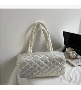 Detail of the soft quilted texture and metallic finish on the silver white tote bag