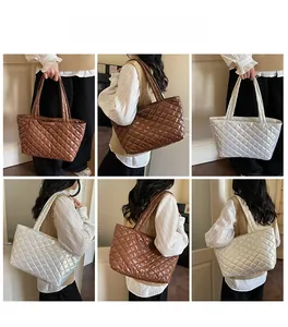 Detailed views of quilted puffer tote bags in coffee and silver on a model