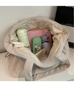 Detailed interior view of a large cream corduroy tote bag showing spacious storage capacity