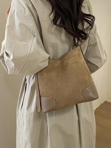Brown suede tote shoulder bag with leather patches and white stitching in minimalist style