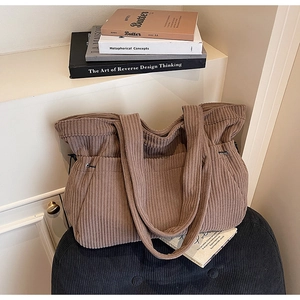 Detail of coffee corduroy tote bag featuring vertical texture and adjustable side drawstrings