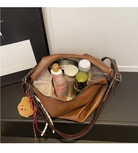 Deep brown tote bag showing spacious interior capacity with skincare items
