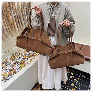 Detail of vintage brown suede tote bags with unique fold design and large capacity