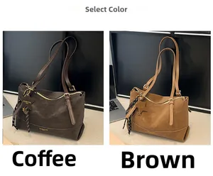 Detail view of suede shoulder bags with star pendants and woven ropes in brown tones