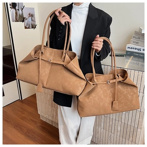 Comparison of large and medium retro brown suede tote bags with decorative straps