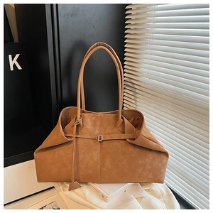 Close-up of brown vintage tote bag with textured faux leather and long shoulder strap