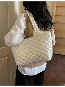 Silver quilted tote bag for women with large capacity shown on a model side view