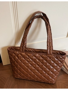 Brown quilted nylon tote bag with rhombus pattern on dark wooden floor for work