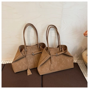 Detailed macro view of retro brown faux suede tote bag featuring fine matte texture