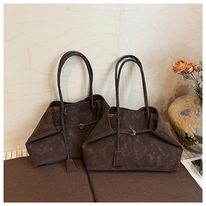 Detailed close-up of dark brown vintage leather tote bags with elegant silver metal buckles