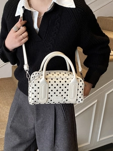 Stylish white polka dot boston bag with dual handles and adjustable shoulder strap