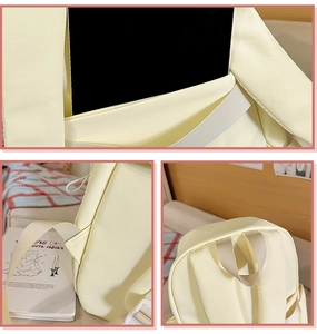 Detail of beige canvas backpack featuring reinforced handle and internal laptop compartment