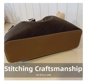 Detail of premium stitching craftsmanship on a vintage brown suede tote bag for women