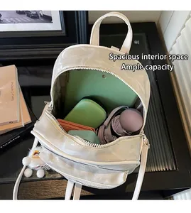 Interior view of off-white faux leather backpack showing spacious storage capacity