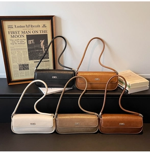 Five vintage baguette bags in various colors displayed on steps with retro decor