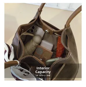 Brown suede tote bag interior view with large capacity and white stitching detail