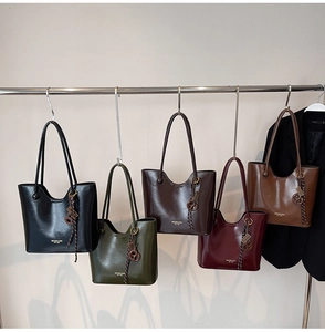 Row of colorful leather tote bags showing various vintage oil wax texture finishes